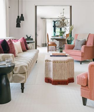 Living room with cream woven carpet and pink chairs