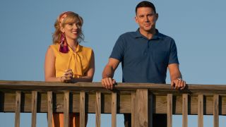 Scarlett Johansson and Channing Tatum stand smiling along a wooden railing in Fly Me To The Moon.