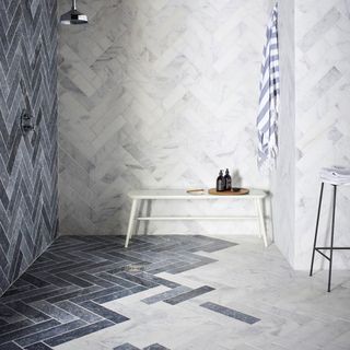 shower room with marble tiles and white bench