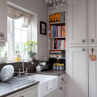 kitchen with white cupboard and book shelf