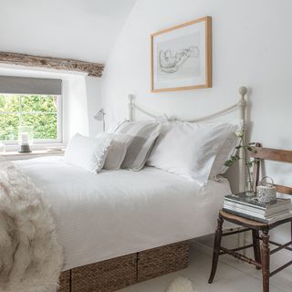 White bedroom with wrought iron bed