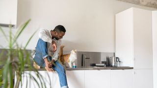 Man sitting on counter with cat