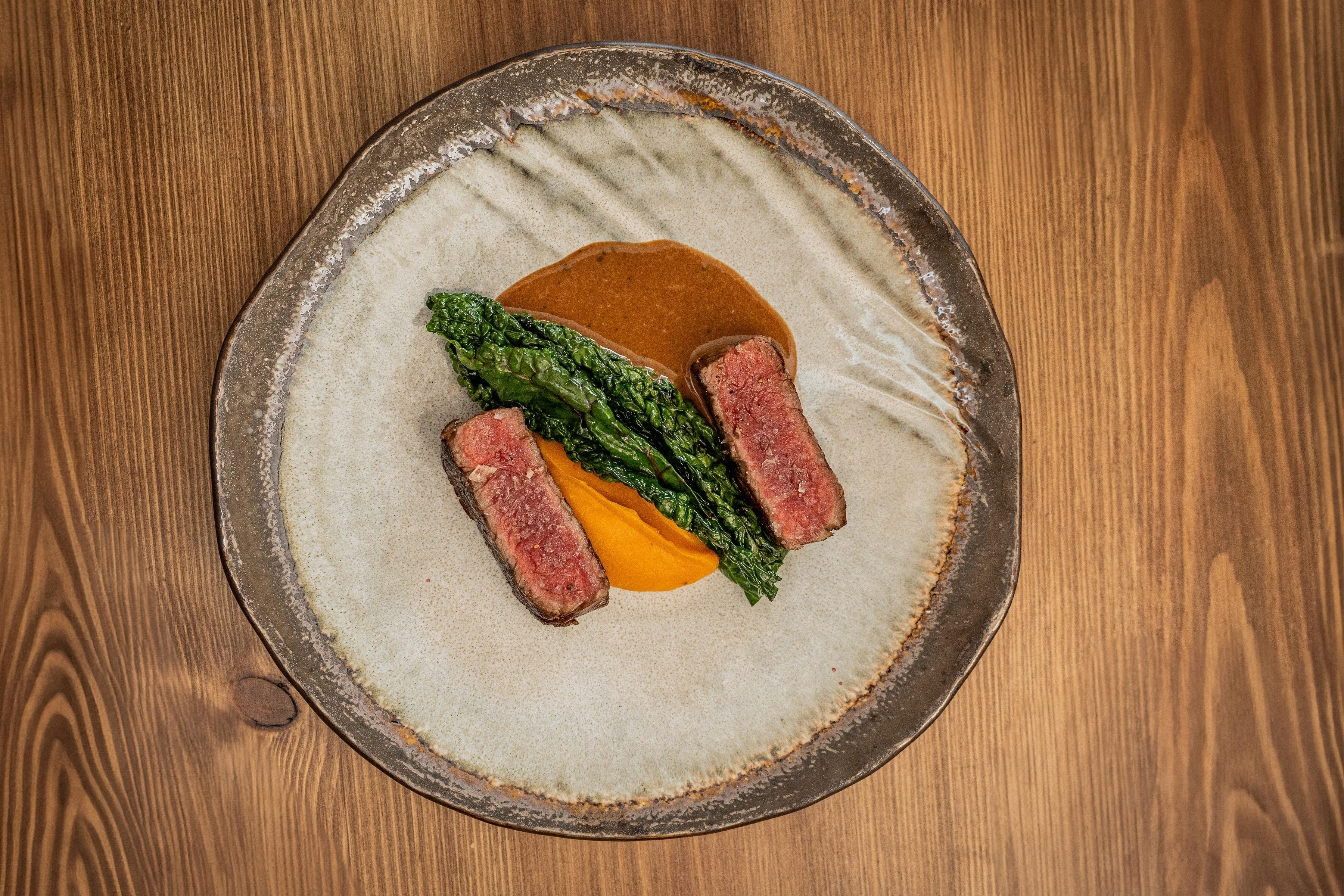 Aged beef sirloin with sweet potato puree and peppercorn sauce