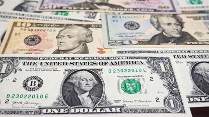 A collage of various American currency is seen, including $1, $10 and $20 bills. 