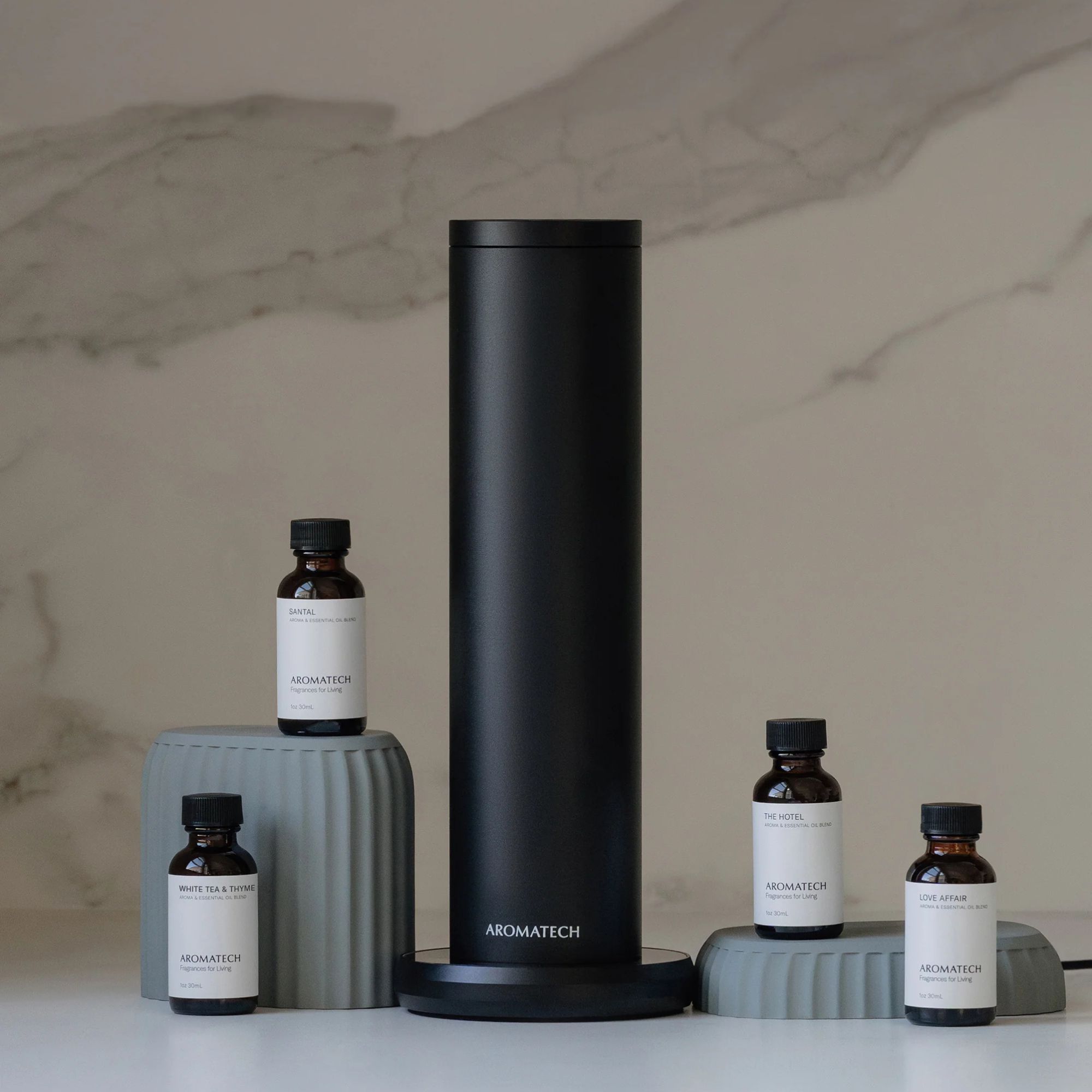 AromaTech AroMini against a marble wall.