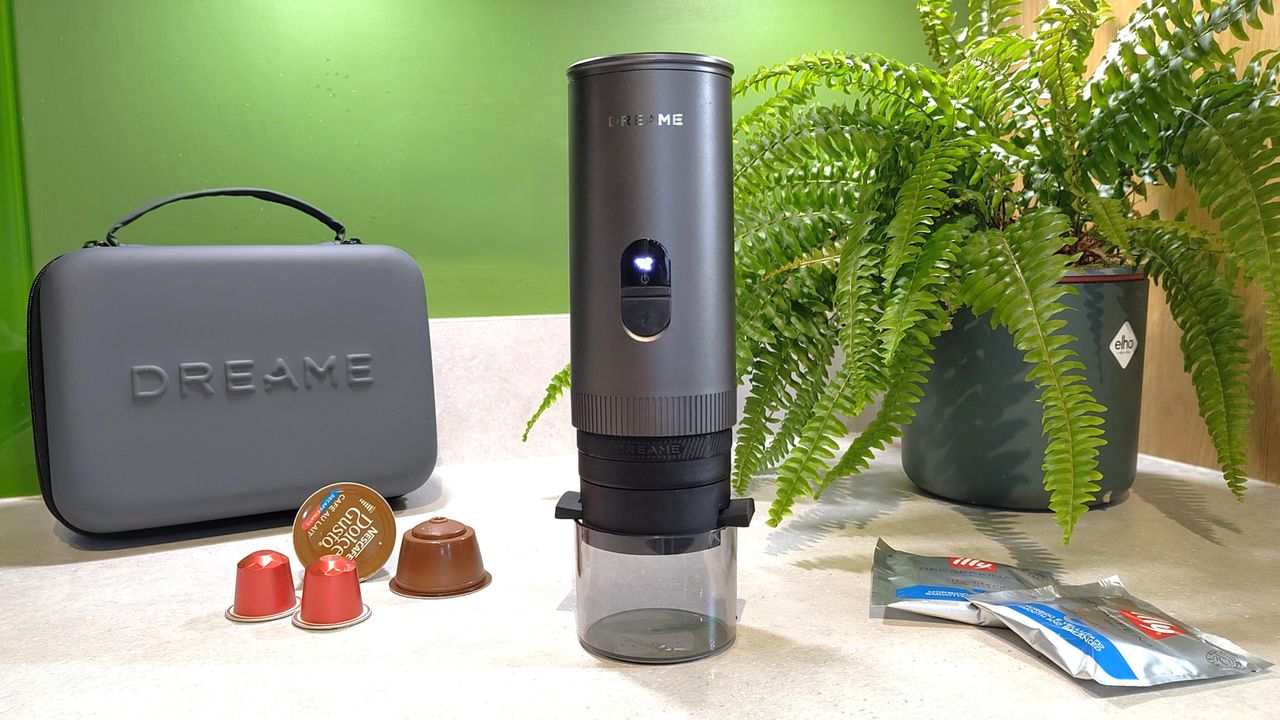Dreame Ecceluxe Go coffee maker on kitchen counter with house plant, carry case, and three types of coffee pods