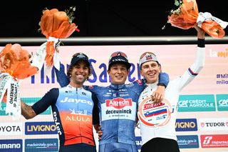 (From L) Second placed Team Jayco Alula's Australian rider Michael Matthews, first placed Alpecin-Deceuninck's Belgian rider Jasper Philipsen and third placed UAE Team Emirates' Slovenian rider Tadej Pogacar celebrate on the podium after the 115th Milan-SanRemo one-day classic cycling race, between Milan and SanRemo, northern Italy, on March 16, 2024. (Photo by Marco BERTORELLO / AFP)