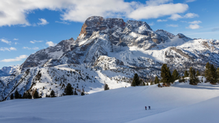 Two hikers in snowy Dolomites