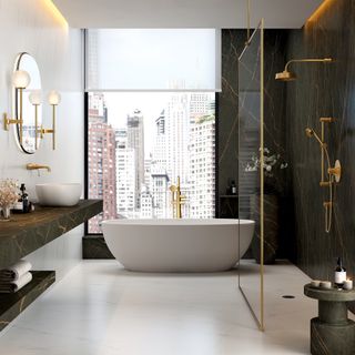 Luxe bathroom with large modern freestanding bath, gold fittings and dark grey marble walls