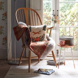 arm chair with cushion and window with radio on side table