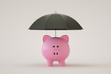 pink piggy bank with a black umbrella over it
