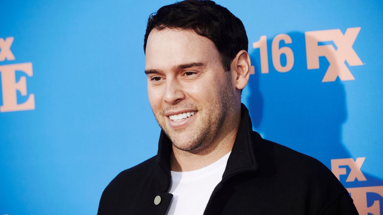 Scooter Braun against red carpet backdrop