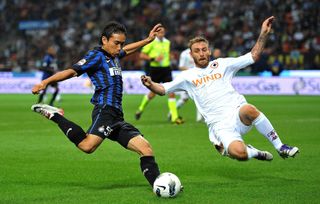 Roma's Daniele De Rossi dives in to block a shot from Inter's Yuto Nagatomo in 2011.