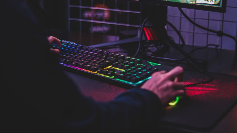 Best gaming keyboards 2022: Colourful keyboard and hand on mouse