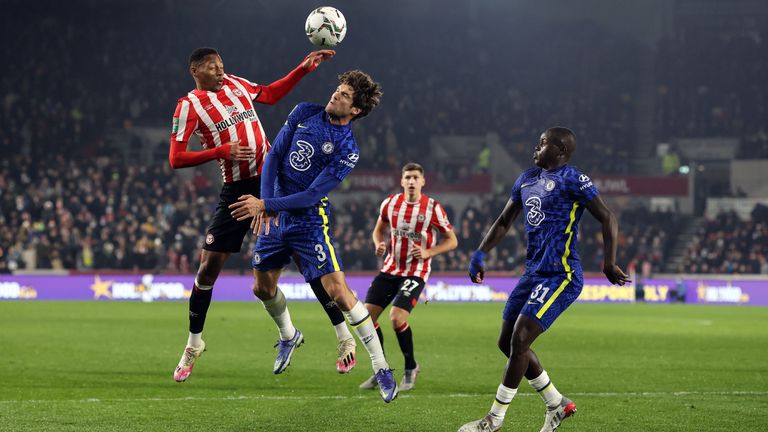 Ethan Pinnock of Brentford and Marcos Alonso of Chelsea go up for a header during the Carabao Cup Quarter Final match between Brentford and Chelsea