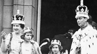 King George VI and Queen Elizabeth with Princess Elizabeth and Princess Margaret Rose, acknowledging the cheers of the crowd from the balcony