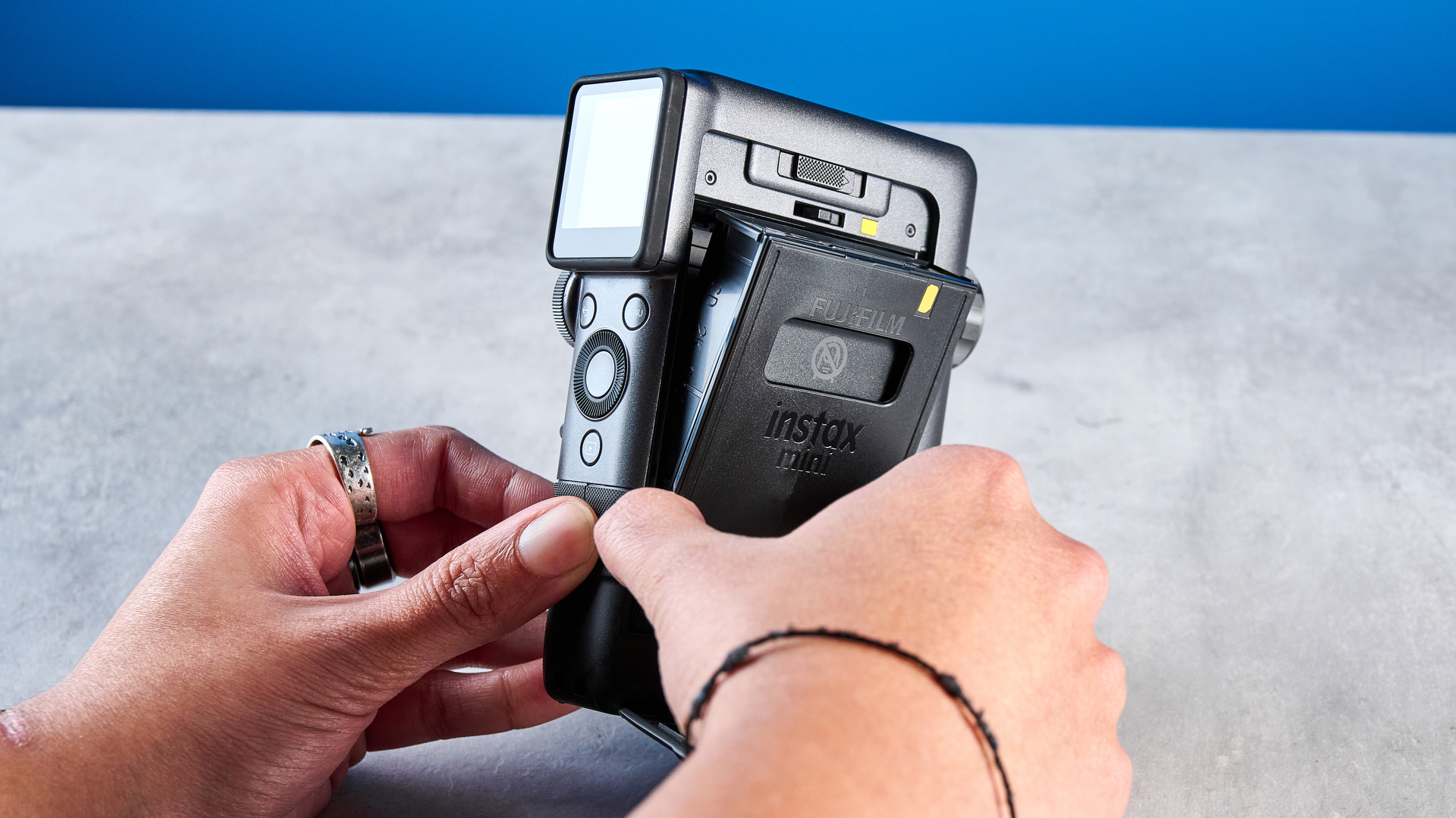 A Fujifilm Instax mini Evo Cinema hybrid instant camera