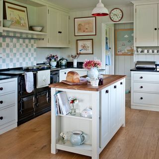 kitchen with wooden flooring and white cabinets