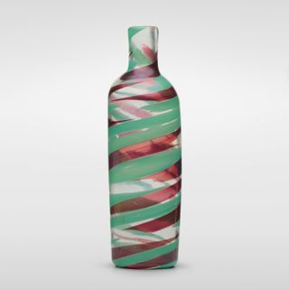 A glass vase with green and red swirls of color.