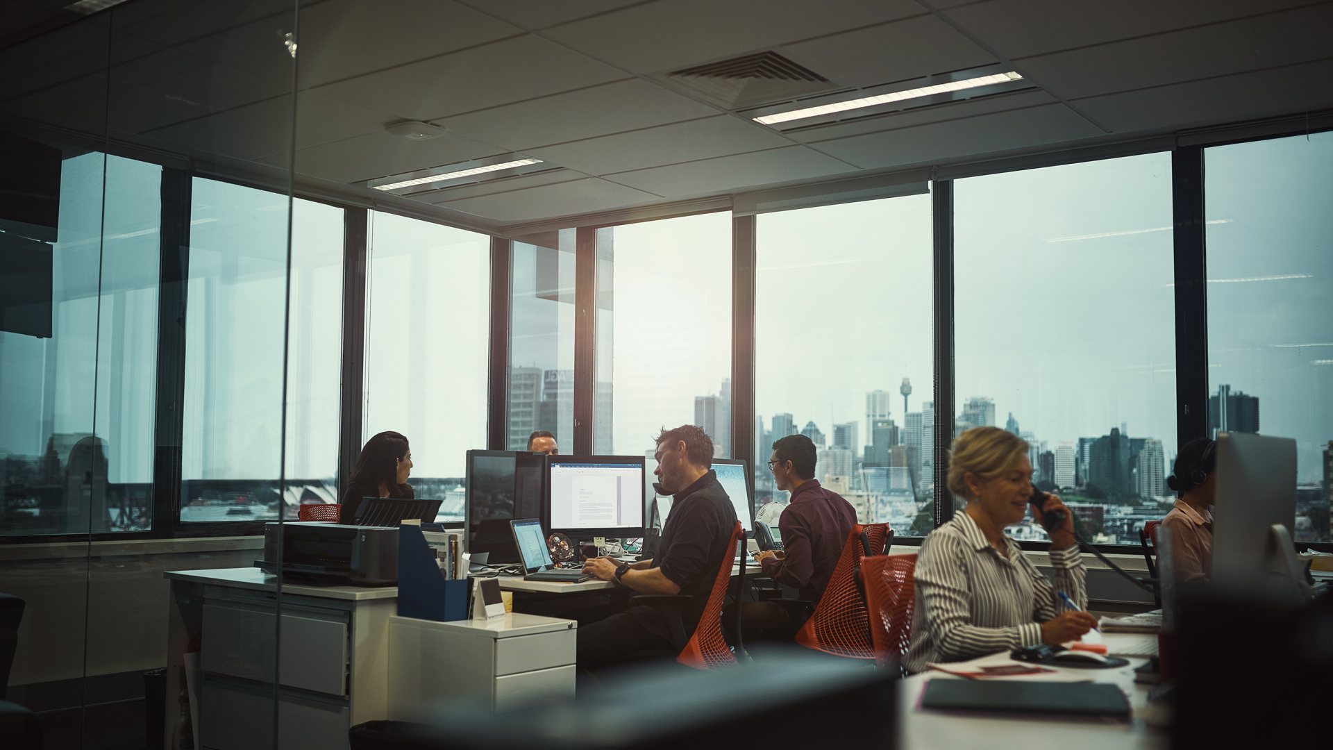 office with workers on computers at desks