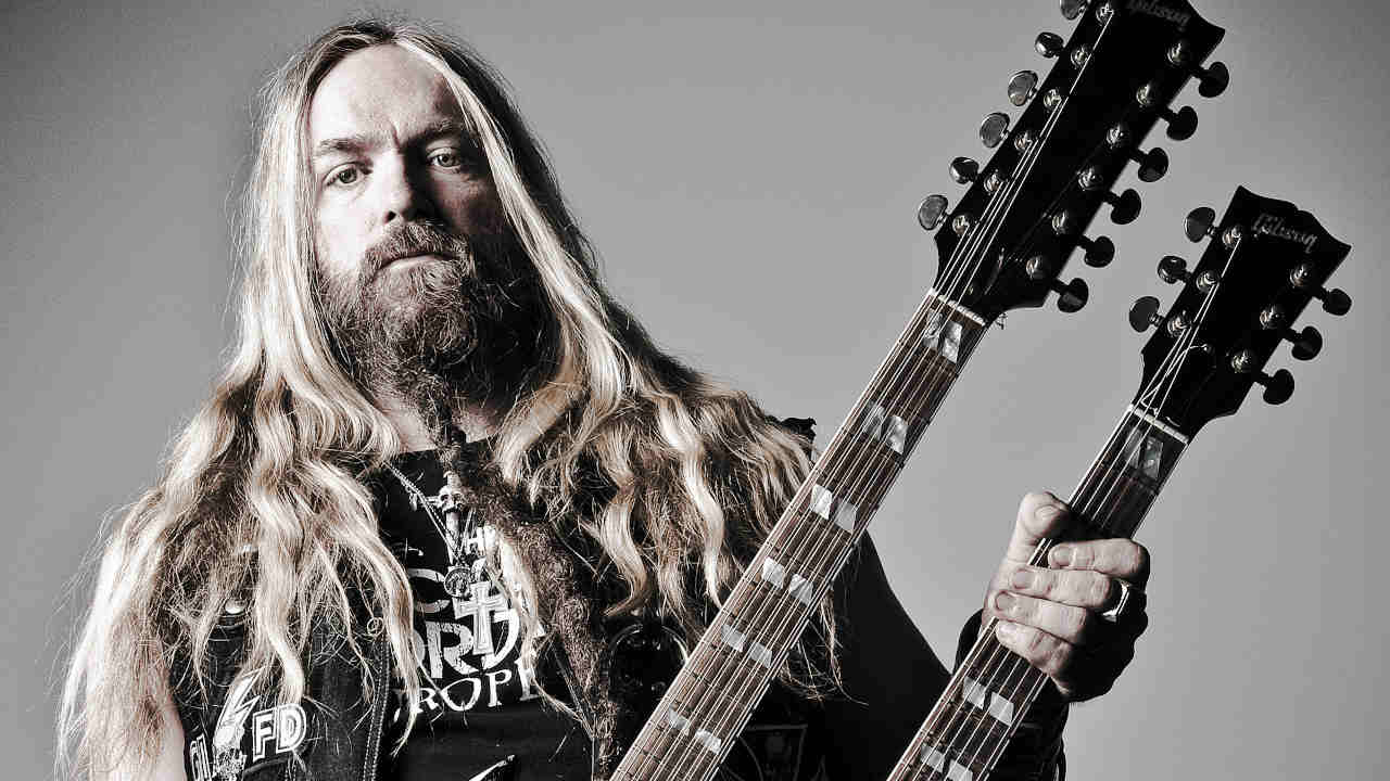 Zakk Wylde posing for a photograph with a guitar