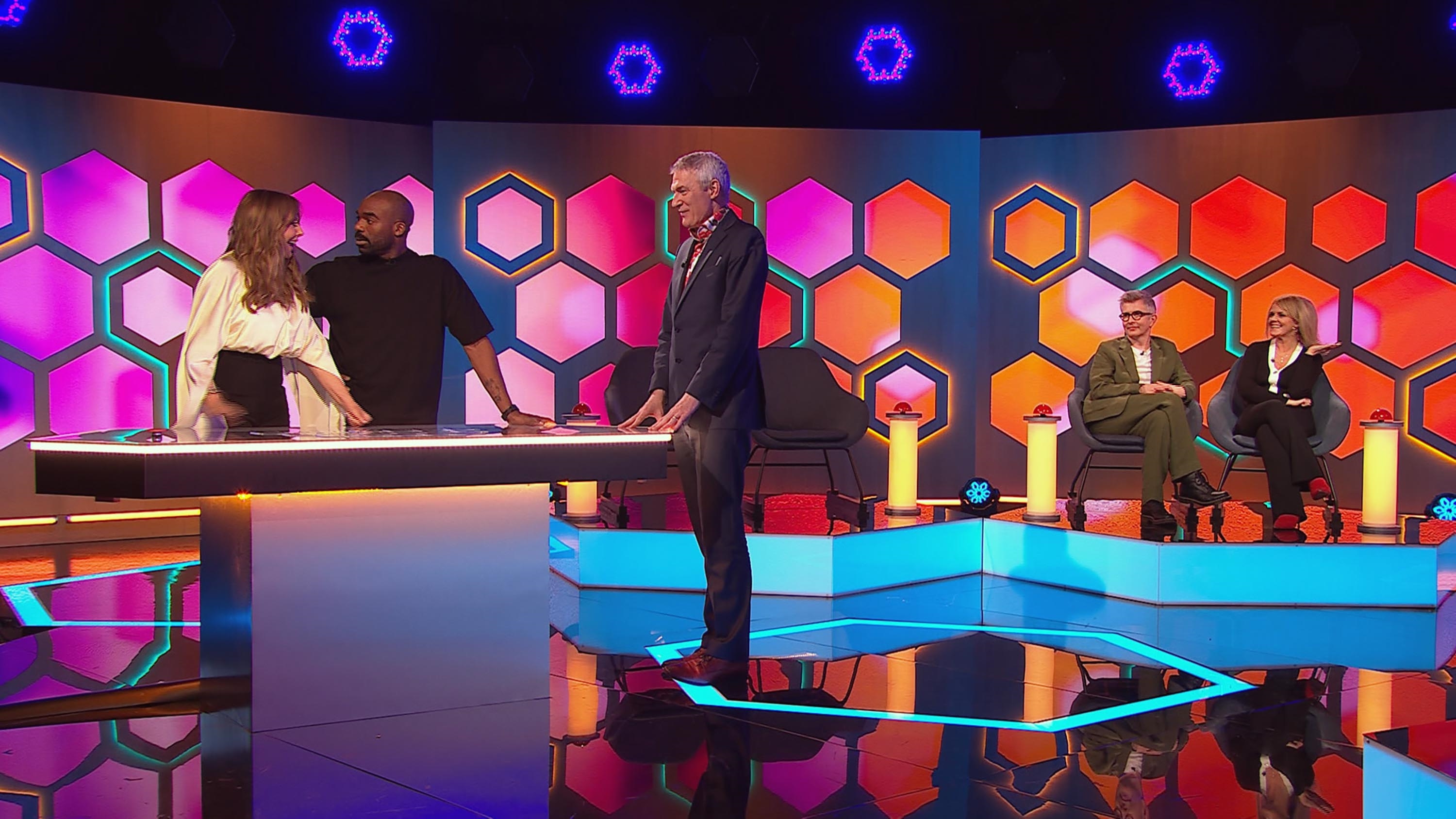 Jeremy Vine oversees a puzzle as Carol Vorderman and Ore Oduba try to solve it.