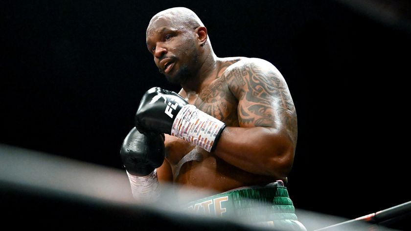 Dillian Whyte in the ring with black boxing gloves and green shorts.