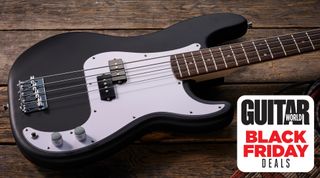 Squier's Debut Series Precision Bass, laid down on a hardwood floor