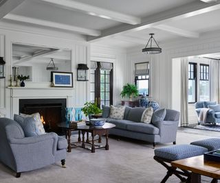 living room with white walls blue sofas