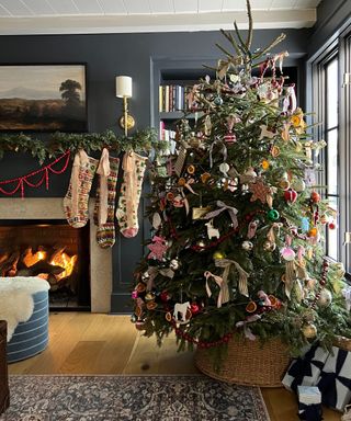 dark blue living room decorated for christmas with a large vintage decorated christmas tree