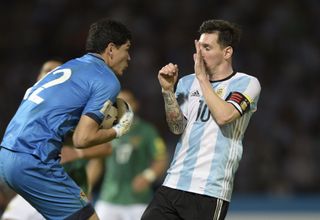 Bolivia goalkeeper Carlos Lampe gets to a ball ahead of Argentina's Lionel Messi in 2016.