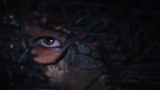 Ghost of Yotei protagonist's eye seen through straw hat
