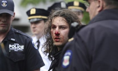New York police arrest a bloodied protester Tuesday.