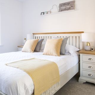 bedroom with white walls bed and side table