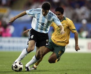 Argentina's Javier Zanetti is chased by Australia's Tim Cahill at the Confederations Cup in 2005.