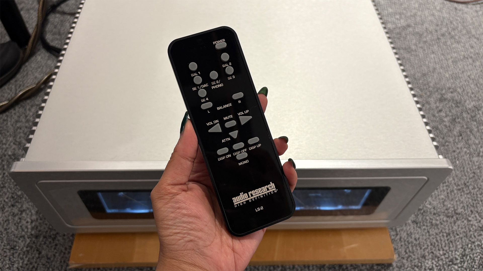 Remote control held in hand over Audio Research S-200 power amp