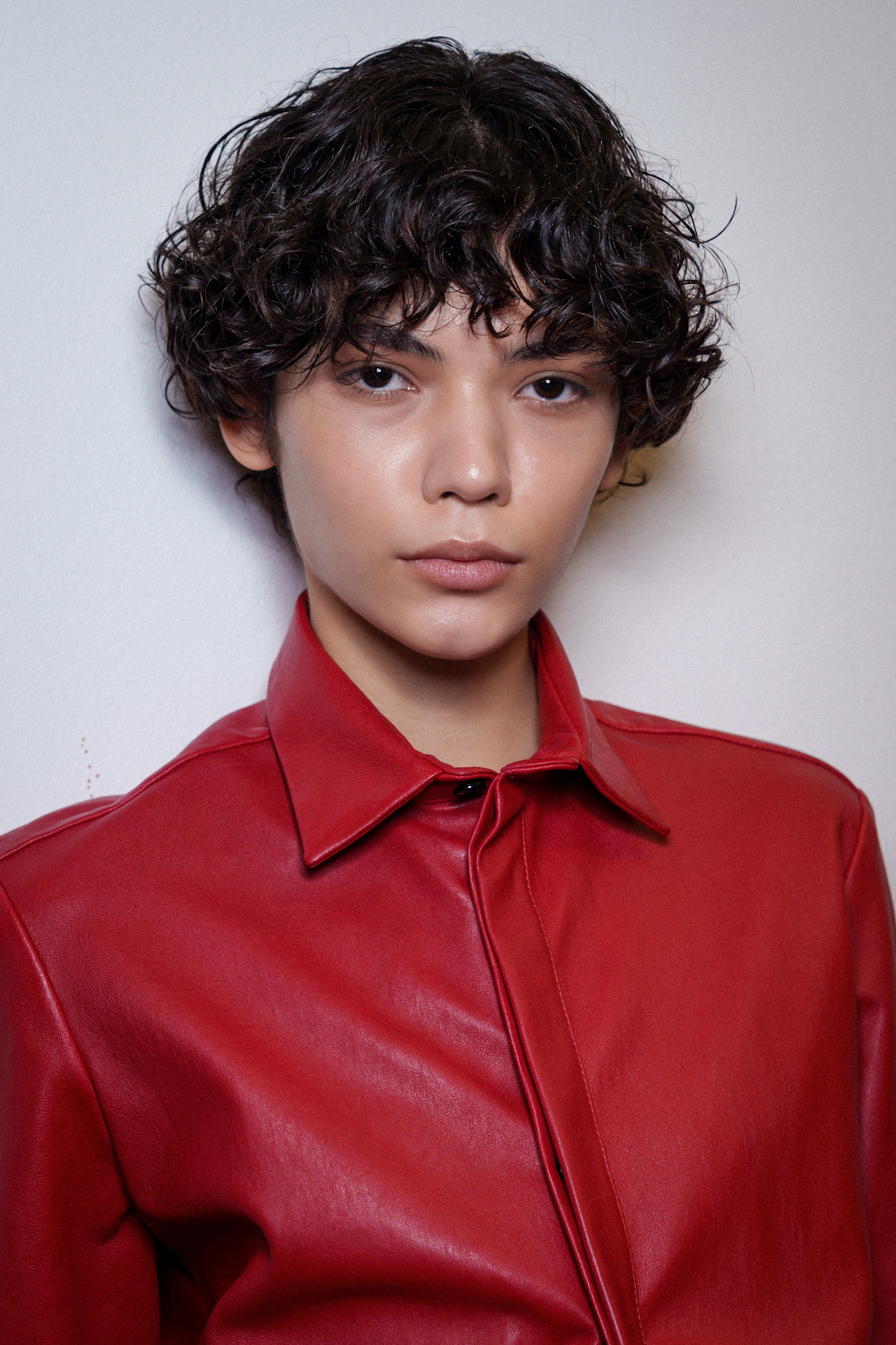 A model showing off a structured, curled bixie cut.