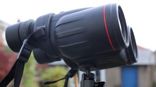 Image shows the Canon 10x42L IS WP binoculars on a tripod.