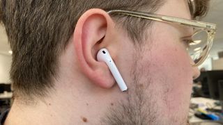Apple AirPod in a man's right ear
