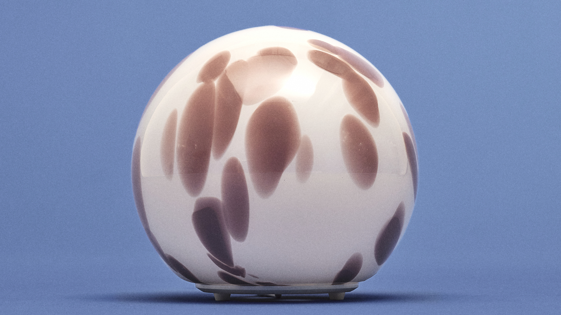 An IKEA FADO lamp on a blue background