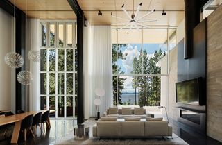 Sunlight bouncing off the living area’s highly polished black concrete floors creates a sensation of floating on water, reflecting the distant landscape of the glassy lake beyond