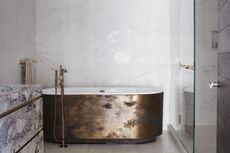 A bathroom with glimmering hardware