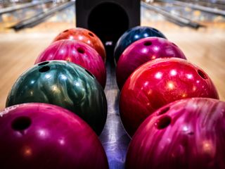 Tenpin bowling balls lined up at the bowling alley