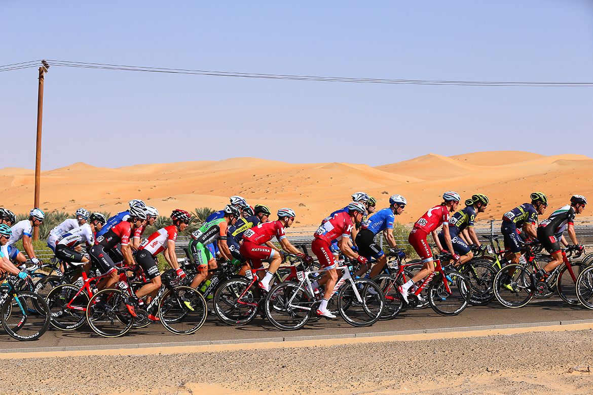 The peloton passes through the desert
