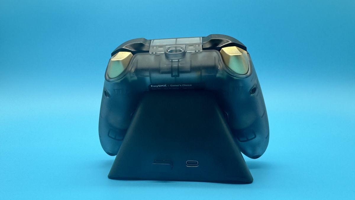 EasySMX D05 black gaming controller from behind on its charging dock, on a blue background