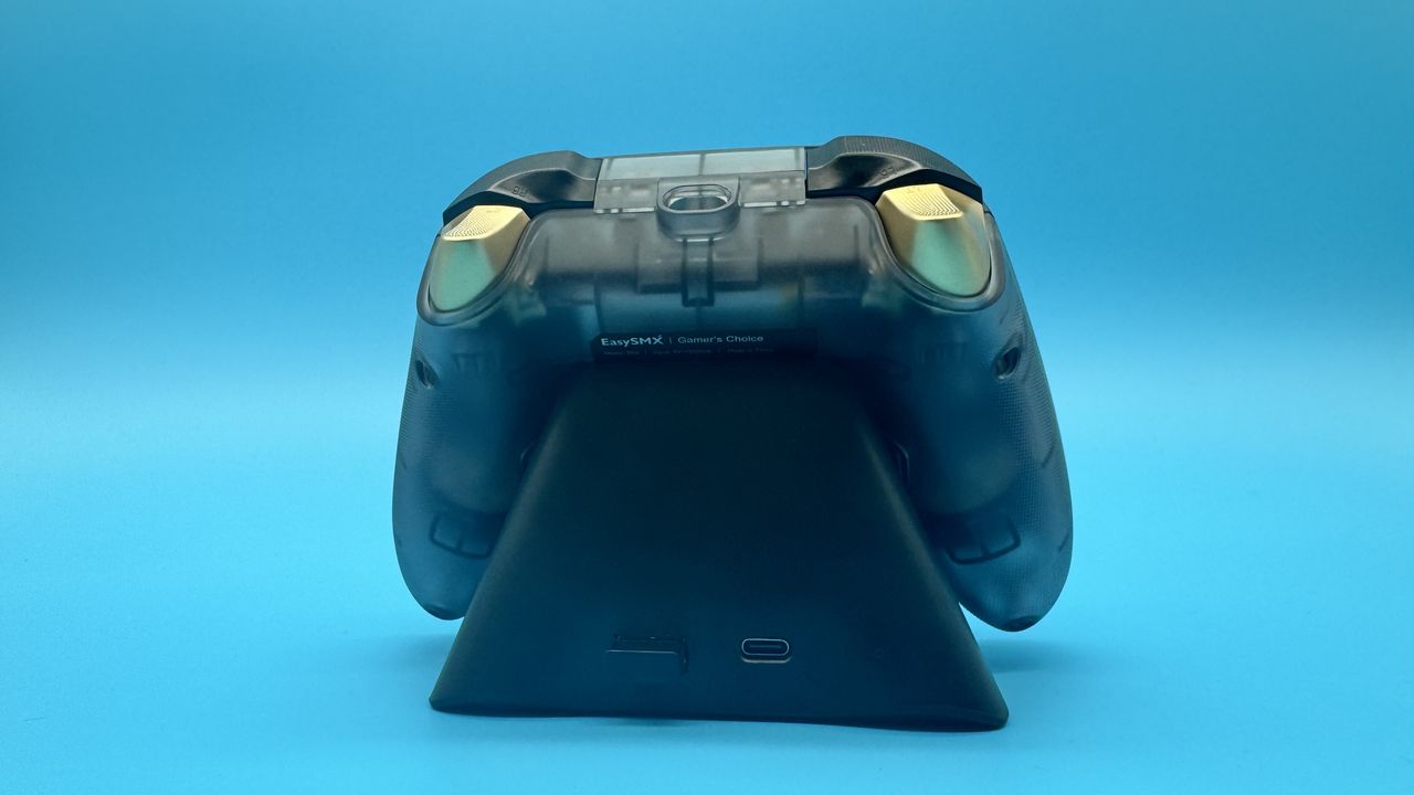 EasySMX D05 black gaming controller from behind on its charging dock, on a blue background