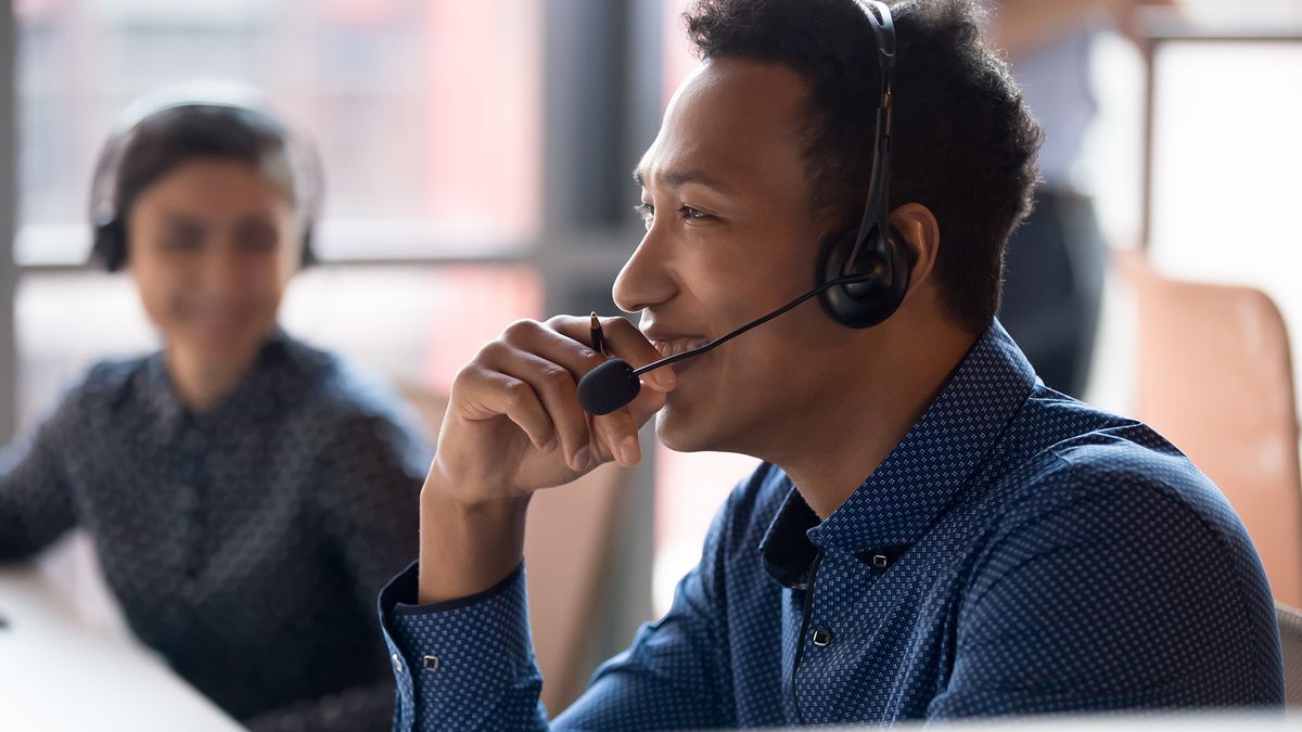 Person using VoIP headset talking to customer