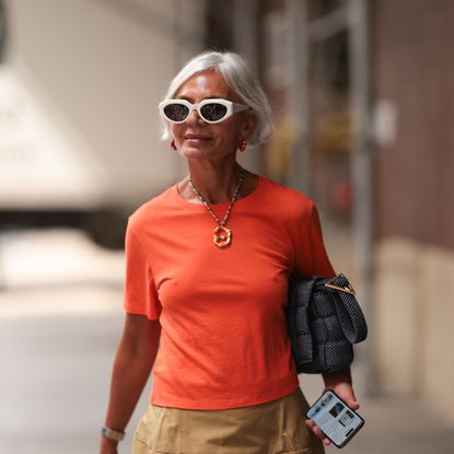 best serums for mature skin - Grece Ghanem is seen outside Tibi show wearing white Bottega Veneta sunnies, red earrings, old Celine necklace, orange tshirt 