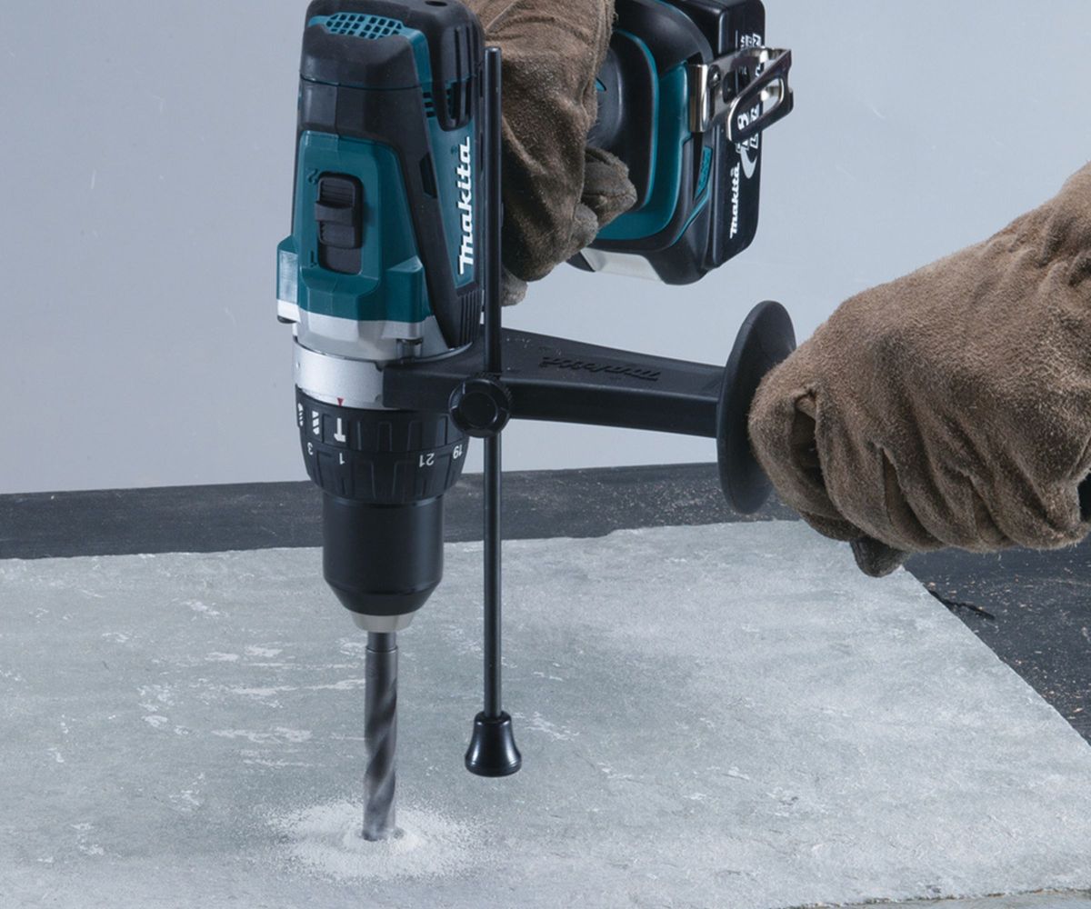 Makita DHP458Z 18V Cordless Hammer Drill being used on masonry
