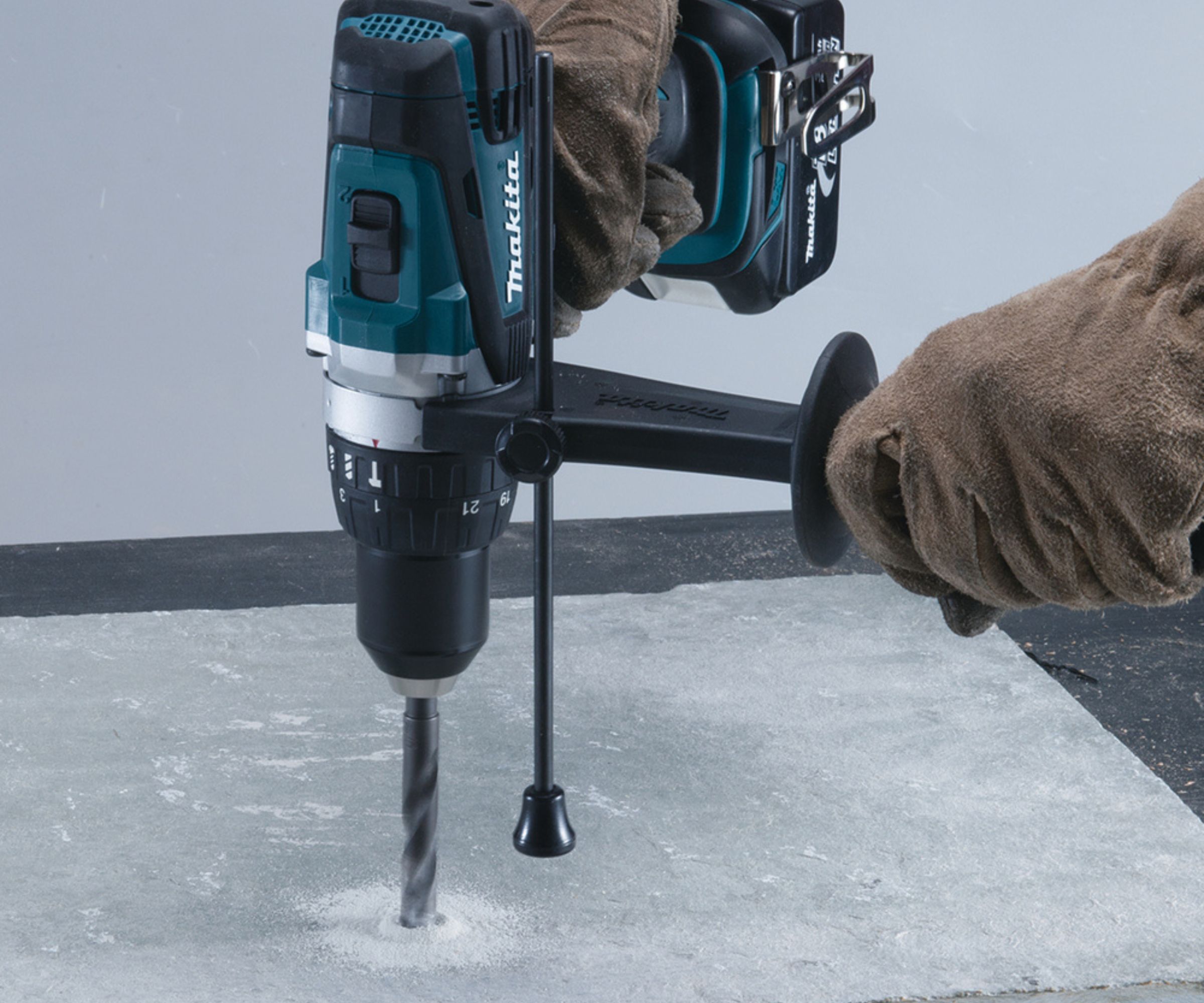 Makita DHP458Z 18V Cordless Hammer Drill being used on masonry